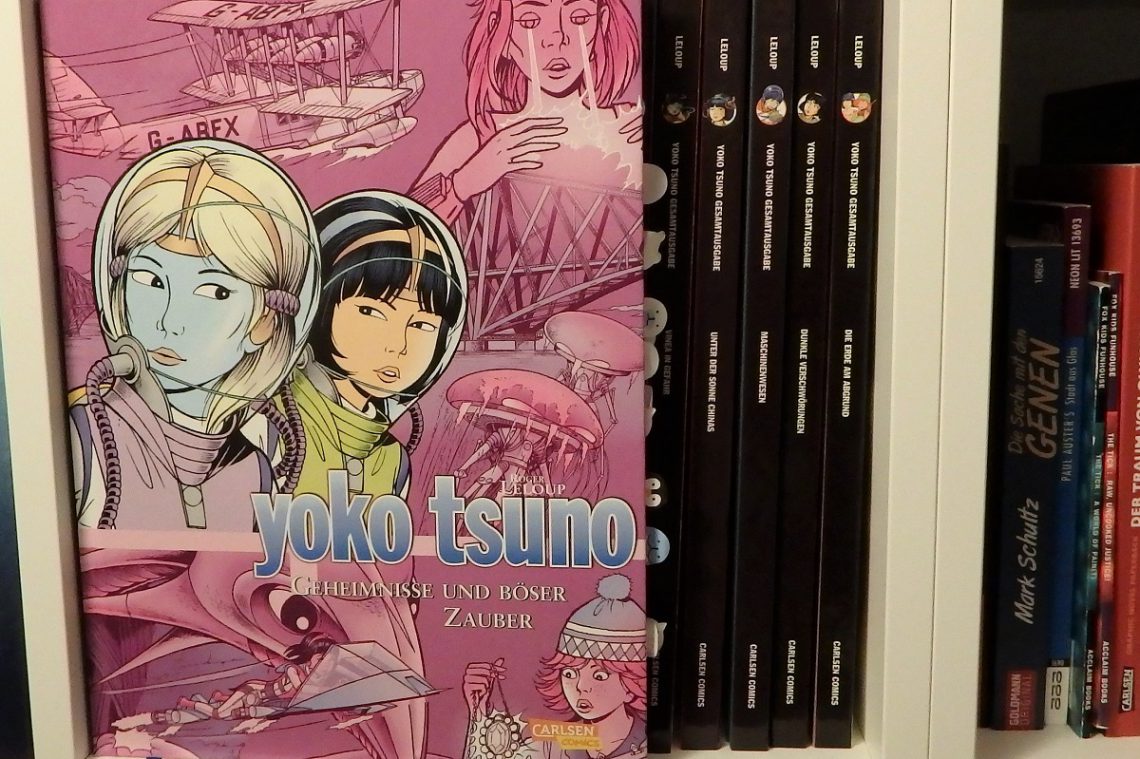 Yoko Tsuno Sammelband 9 hat einen rosa-lila Hintergrund und zeigt Yoko und Khany auf dem Cover